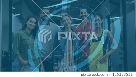 Collaborating team using blue holographic interface in open office, glass partitions and LED lights 135393531