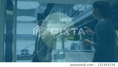 Floating translucent coin graphic displaying NFT Crypto Currency Non-Fungible Token in atrium 135393534