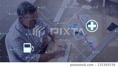 Typing man in checkered shirt analyzing data overlays at office desk, with color wheel and keyboard 135393539