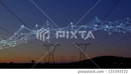 Stretching transmission towers across hills at dusk, with glowing digital network overlay 135393572