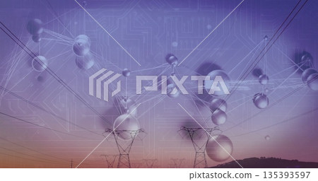 Sending power two steel lattice towers standing on hillside at dusk with lines, reflective spheres 135393597