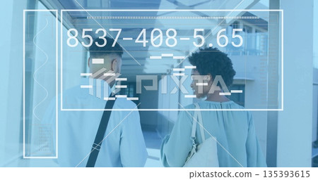 Business colleagues walking in corridor carrying black bag and cream tote with digital overlay 135393615