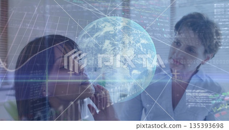 Two business professionals analyzing data in meeting room, with holographic globe and code overlays Two business professionals analyzing data in meeting room, with holographic globe and code overlays 135393698