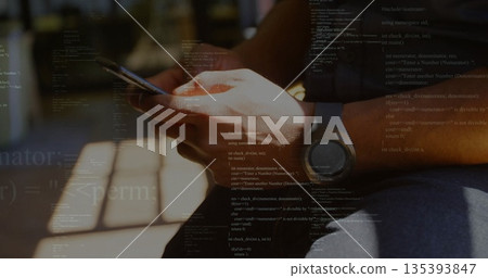 Holding smartphone, adult hands scrolling on wooden bench, with smartwatch and code overlay 135393847