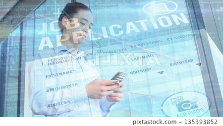 Asian man wearing shirt reviewing form on smartphone near glass wall in office, with code overlay 135393852