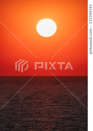Beautiful red and orange sunrise over the sea. Beautiful red and orange sunrise over the sea. 135394343