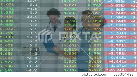 Doctors in coat and scrubs reviewing financial data in clinic, with blue clipboard and stethoscopes Doctors in coat and scrubs reviewing financial data in clinic, with blue clipboard and stethoscopes 135394482