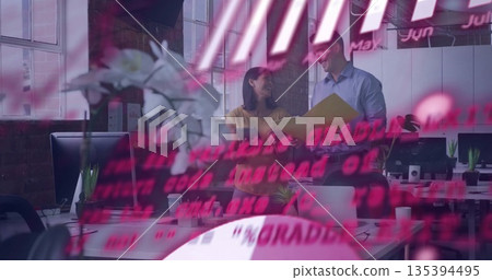 Colleagues reviewing yellow binder beside desk in open plan office, pink code overlay, copy space 135394495