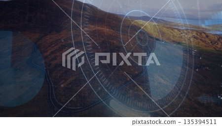 Rugged hillside descending coastal bay, showing winding road and HUD overlay with circles and lines Rugged hillside descending coastal bay, showing winding road and HUD overlay with circles and lines 135394511