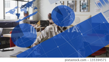 Writing senior man wearing checkered shirt working on laptop at office table, with network graphics 135394571
