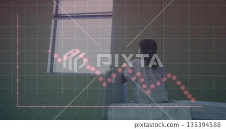 Girl wearing hospital gown sitting on bed, with digital grid and line chart overlay, copy space Girl wearing hospital gown sitting on bed, with digital grid and line chart overlay, copy space 135394588