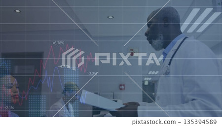 Mature male physician reviewing charts in hospital room, colleagues watching, digital overlay Mature male physician reviewing charts in hospital room, colleagues watching, digital overlay 135394589