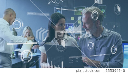 Collaborating senior analyst and project manager reviewing data on laptop in office, with charts Collaborating senior analyst and project manager reviewing data on laptop in office, with charts 135394640