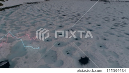 Displaying snow-covered ice sheet revealing melt holes on frozen expanse, with red blue line graphs Displaying snow-covered ice sheet revealing melt holes on frozen expanse, with red blue line graphs 135394684