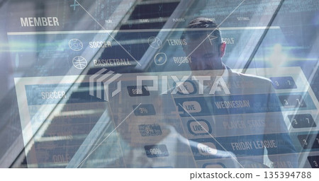 Suit-clad businessman interacting with AR dashboard in glass office, with icons, percentage bars 135394788