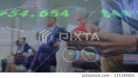 Smartphone hand displaying stock charts over lanyarded colleagues on conference chairs, copy space Smartphone hand displaying stock charts over lanyarded colleagues on conference chairs, copy space 135394805