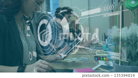 Operating mature woman moving mouse at office with tablet stylus and holographic charts, copy space Operating mature woman moving mouse at office with tablet stylus and holographic charts, copy space 135394819