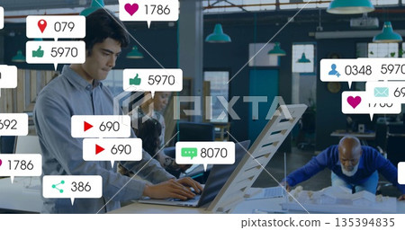 Typing Native American man working at coworking space with scale model and social icons, copy space Typing Native American man working at coworking space with scale model and social icons, copy space 135394835