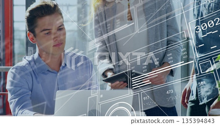 Collaborating professionals reviewing digital data overlays in office workspace, laptop and tablet Collaborating professionals reviewing digital data overlays in office workspace, laptop and tablet 135394843