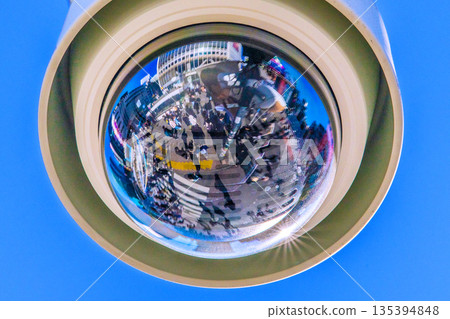 Tokyo cityscape, Japan. View of Shibuya Scramble Crossing with street corner security cameras and beams of light. A ray of hope for a new era. Tokyo cityscape, Japan. View of Shibuya Scramble Crossing with street corner security cameras and beams of light. A ray of hope for a new era. 135394848