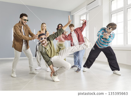 Group of young people practice urban dance in modern studio 135395663
