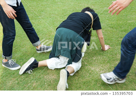 A person being spanked by two men as a punishment game A person being spanked by two men as a punishment game 135395703