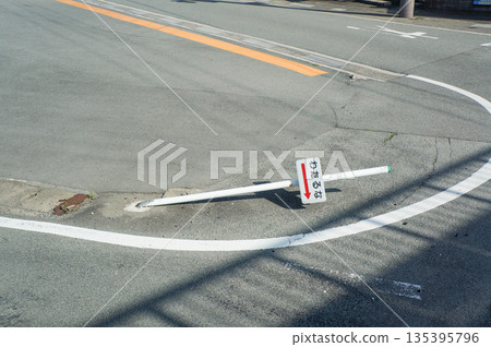 A sign reading "Do not cross" broken by a car collision 135395796