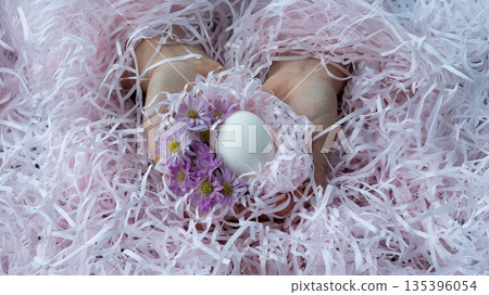 Easter Egg in Hands with Spring Flowers Easter Egg in Hands with Spring Flowers 135396054