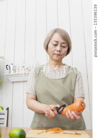 Senior woman happily cooking in the kitchen 135396139