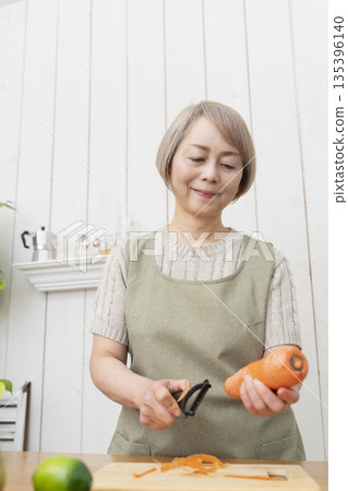Senior woman happily cooking in the kitchen 135396140