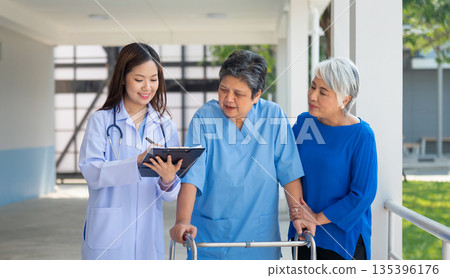 doctor is talking to  woman in  blue uniform 135396176