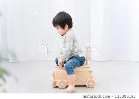 Child playing with toy car 135396185