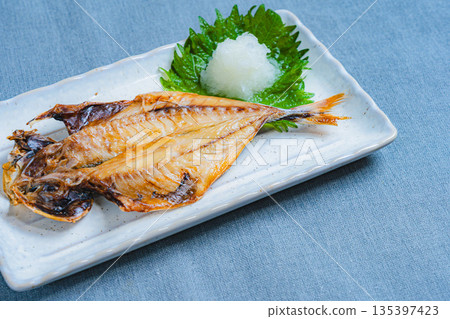 Filleted horse mackerel served on a white square plate with grated daikon radish and shiso leaves Filleted horse mackerel served on a white square plate with grated daikon radish and shiso leaves 135397423