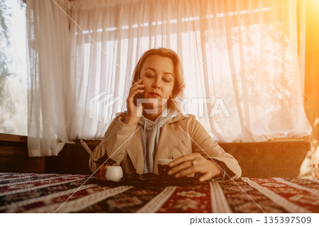 Woman on Phone with Coffee and Turkish Delight Woman on Phone with Coffee and Turkish Delight 135397509