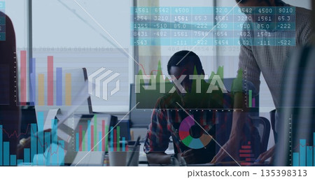Pointing man in sweater guiding coworker in plaid at office desk with monitor, floating data charts Pointing man in sweater guiding coworker in plaid at office desk with monitor, floating data charts 135398313