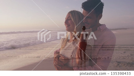 Embracing couple wearing knit sweater and pink shirt on sandy shore at sunset, with pastel sky Embracing couple wearing knit sweater and pink shirt on sandy shore at sunset, with pastel sky 135398433