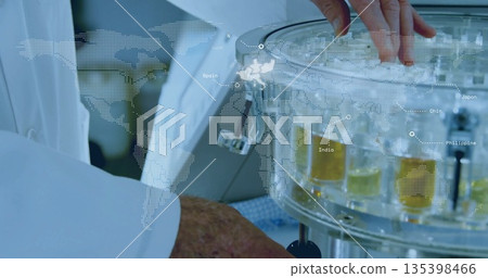Scientist in lab coat adjusting reactor knob in lab with hologram world map overlay, copy space 135398466
