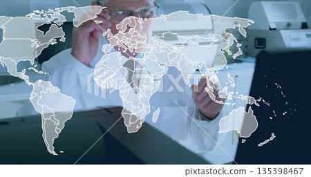 Scientist in lab coat and glasses raising hand toward map overlay in lab, with diagnostic equipment 135398467