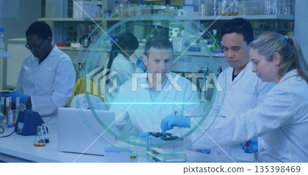 Conducting experiments five scientists in lab coats and gloves at lab bench, with test tubes Conducting experiments five scientists in lab coats and gloves at lab bench, with test tubes 135398469