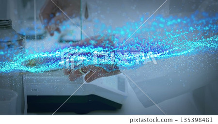Lab tech holding steel container on digital scale at white bench, with blue data stream flowing Lab tech holding steel container on digital scale at white bench, with blue data stream flowing 135398481