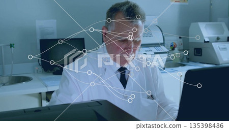 Analyzing technician wearing lab coat and tie focusing on computer screen in lab, with data overlay Analyzing technician wearing lab coat and tie focusing on computer screen in lab, with data overlay 135398486