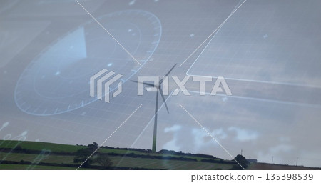 Solitary wind turbine rotating blades on grassy hill, with hedgerows, trees, digital HUD overlays 135398539