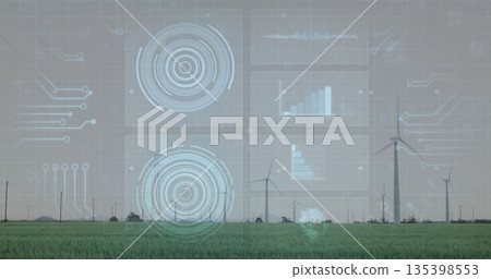 Displaying HUD overlay monitoring wind turbine performance above rural green field, data charts 135398553