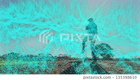Standing male silhouette holding smartphone on rocky mound, with cyan digital overlay, copy space Standing male silhouette holding smartphone on rocky mound, with cyan digital overlay, copy space 135398610