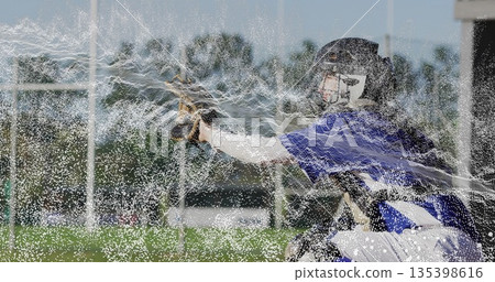 Leaning baseball catcher extending gloved hand on baseball field, with mitt and catcher's helmet Leaning baseball catcher extending gloved hand on baseball field, with mitt and catcher's helmet 135398616
