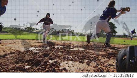 Stretching catcher wearing mitt reaching for softball throw on muddy infield, copy space 135398618