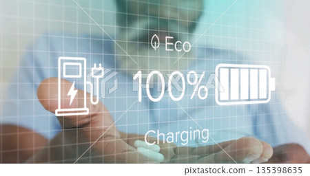 Holding out palm midadult man wearing light blue shirt in studio, projecting eco charging interface 135398635