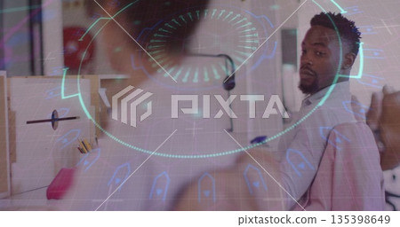 Turning office worker glancing back in workspace, with holographic UI and monitors, copy space 135398649