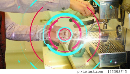 Frothing barista hands creating microfoam at coffee counter, with milk pitcher and red tie detail 135398745
