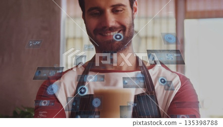 Holding frothed coffee cup, barista wearing apron showing holographic display at cafe counter Holding frothed coffee cup, barista wearing apron showing holographic display at cafe counter 135398788